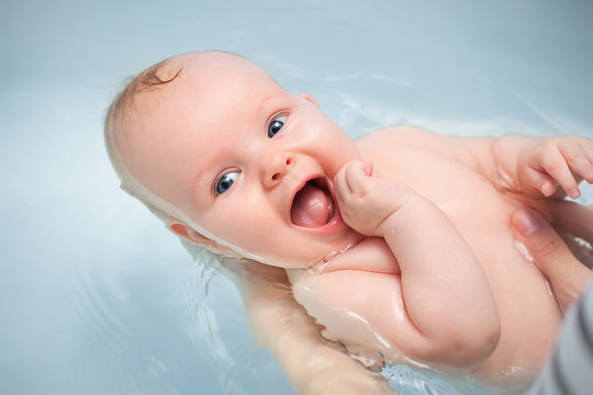 happy baby enjoying a bath