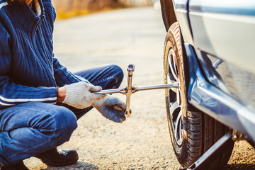 man changing wheel on a car