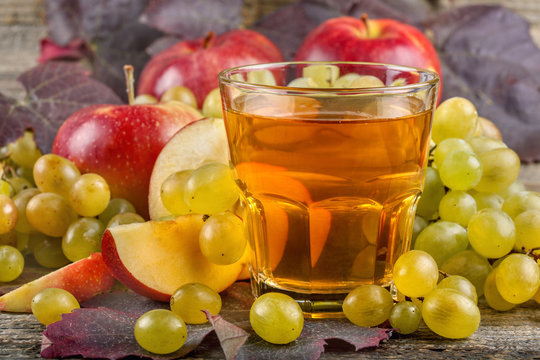 A glass of fresh and healthy apple and grape juice