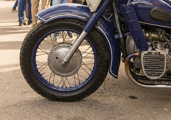 front wheel detail of a blue motorcycle motor wing close-up techno background