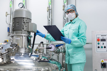plant picture, scientist standing near big steel tank with tablet