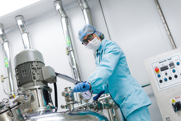 plant picture, scientist standing near big steel tank with tablet