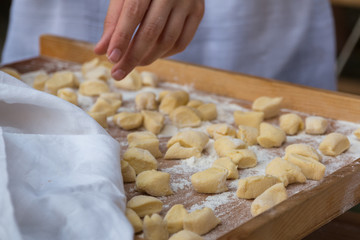 Small Dumplings on Wooden Board with Flour: Italian Gnocchi Past