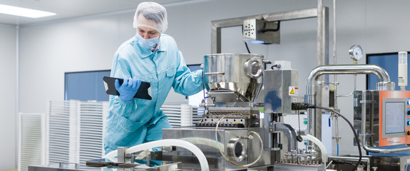 scientist making notes about machine