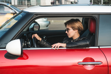 Portrait of smiling businesswoman driving her car.