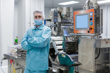 plant picture, factory worker is standing near machine, steel machines, manufacture