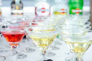 Glasses of martini with olives and glasses with cognac. Alcoholic beverages served at bar. Club atmosphere.