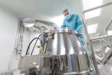 scientist look in steel tank in laboratory