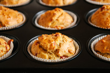 Homemade muffins with bacon and cheese in a tin. Healthy snack or breakfast meal.