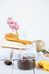 Fototapeta na wymiar Spa and bathroom aromatherapy accessories with lemon fruit. coffee coconut scrub hyacinth towel