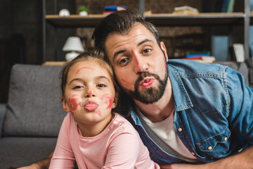 father and daughter with painted faces