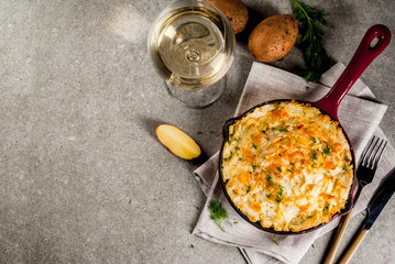 Skillet Shepherd's Pie, british casserole in cast iron pan, with minced meat, mashed potatoes and vegetables, on gray stone background, copy space top view