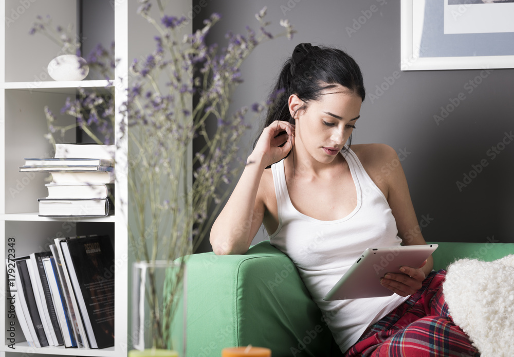 Wall mural woman with tablet at home