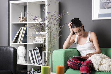 Thoughtful woman with tablet