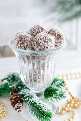Chokladbollar, chocolate-oats sweets in coconut shavings, traditional Christmas candies in Sweden, selective focus