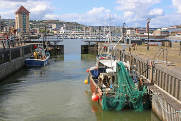 Fototapeta na wymiar Fishing boat entering Swansea Harbour