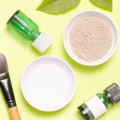 Top view of different cosmetics products on yellow background