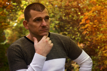 Thoughtful man in the autumn forest