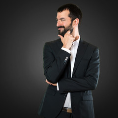 Handsome businessman looking lateral on black background