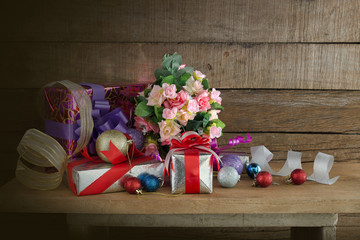 Gifts and ornament on the plank and old wooden wall for Happy new Year and Merry christmas