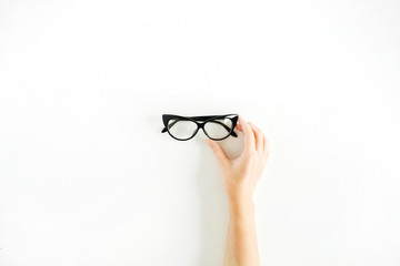 Glasses in woman hand. Minimal flat lay, top view.