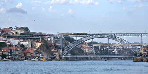 Landscape view on the old town with river and famous iron bridge during the sunset in Porto city, Portugal