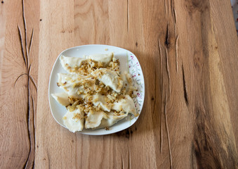 Dumplings on a plate with fried onion