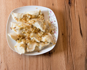 Dumplings on a plate with fried onion