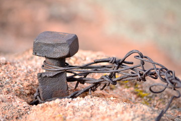Rusted Spike In Granite Rock