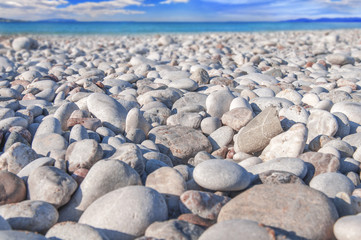Close view of small and big pebble stone with sea background