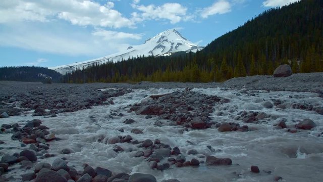 Snowy mountain peak behind snowmelt glacial melt stream White River Mt. Hood Spring Forest Oregon Cascade Mountains