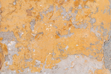 Obraz na płótnie Canvas Close view of yellow building wall cracked and broken architecture concrete texture