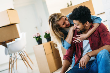 home, people, moving and real estate concept - happy couple having fun while moving in