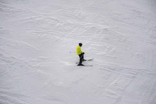 Close up of lonely skier in the snowy mountains.