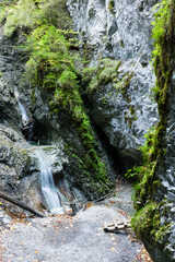 Sucha Bela gorge in Slovensky raj National park, Slovakia. Hikiing Path. Sucha Bela gorge is most popular and one of the most attractive trails. Picture shows Okienkovy vodopad waterfall. - obrazy, fototapety, plakaty