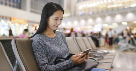 Woman use of mobile phone in airport