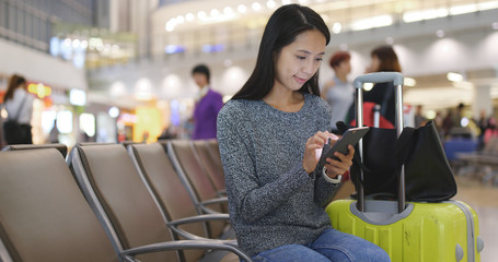 Woman use of mobile phone in Hong Kong airport
