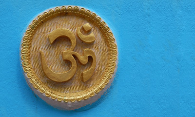 Wall art of Hindu religious symbol om or aum in a temple