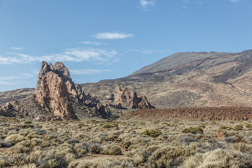 View of large volcanic lava rocks in the middle of a large arid landscape, Tenerife