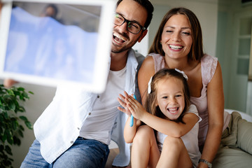 Obraz premium Happy family taking selfie in their house