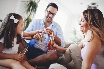 Happy family drinking juice together in their house