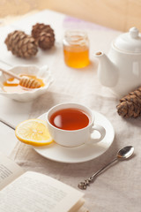 tea and honey on white background, winter or autumn concept, vertical
