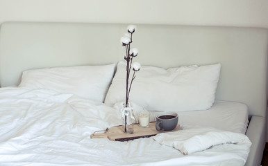 Autumn cozy breakfast in bed. Romantic breakfast. Cotton, a cup of hot coffee, a candle. Autumn...