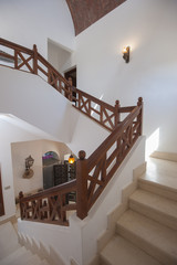 Obraz premium Marble staircase in luxury villa home with wooden bannister