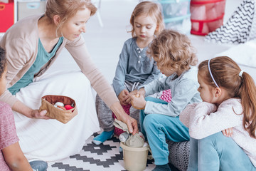 Teacher giving toys children