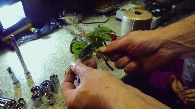 Man helping little girl to tie up a small decoration she made before playing and learnig through game. Filmed in slow motion hd.