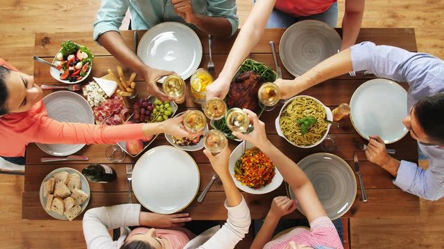 group of people eating and drinking wine at table