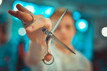 Hairdresser's hands cutting hair. Scissors in the hands of a barber