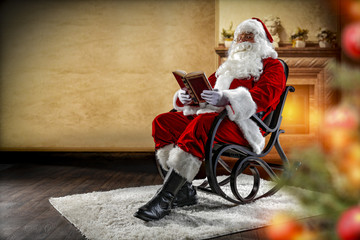 Santa Claus sitting in a wooden rocking chair. In the foreground is a fuzzy Christmas tree with baubles and lights. On the third floor is a wall with a fireplace. 