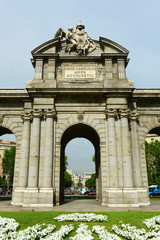 Fototapeta na wymiar Puerta de Alcala (Alcala Gate) is a Neo-classical monument by Carlos III in the Plaza de la Independencia (Independent Square) in Madrid, Spain.